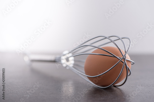 Brown egg trapped in whisk