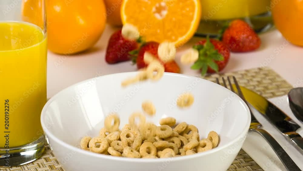 Breakfast cereal being poured into a bowl in slow motion. Breakfast cereal being poured into a bowl in slow motion.