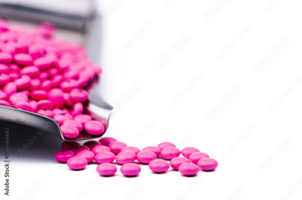 Pile of pink round sugar coated tablets pills on drug tray with copy space.  Pills for treatment anti anxiety, antidepressant and migraine headache  prophylaxis. Healthcare in seniors or older people Stock-Foto