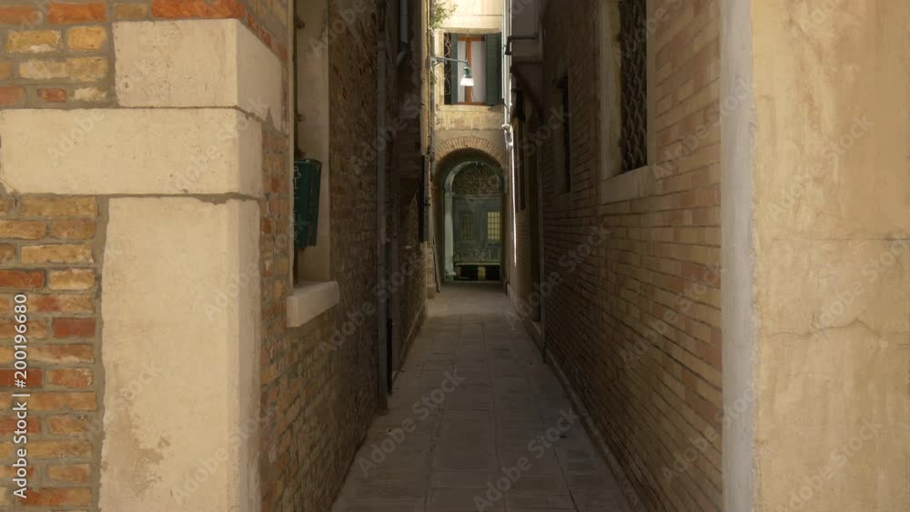 Narrow street between brick buildings Narrow street between brick buildings