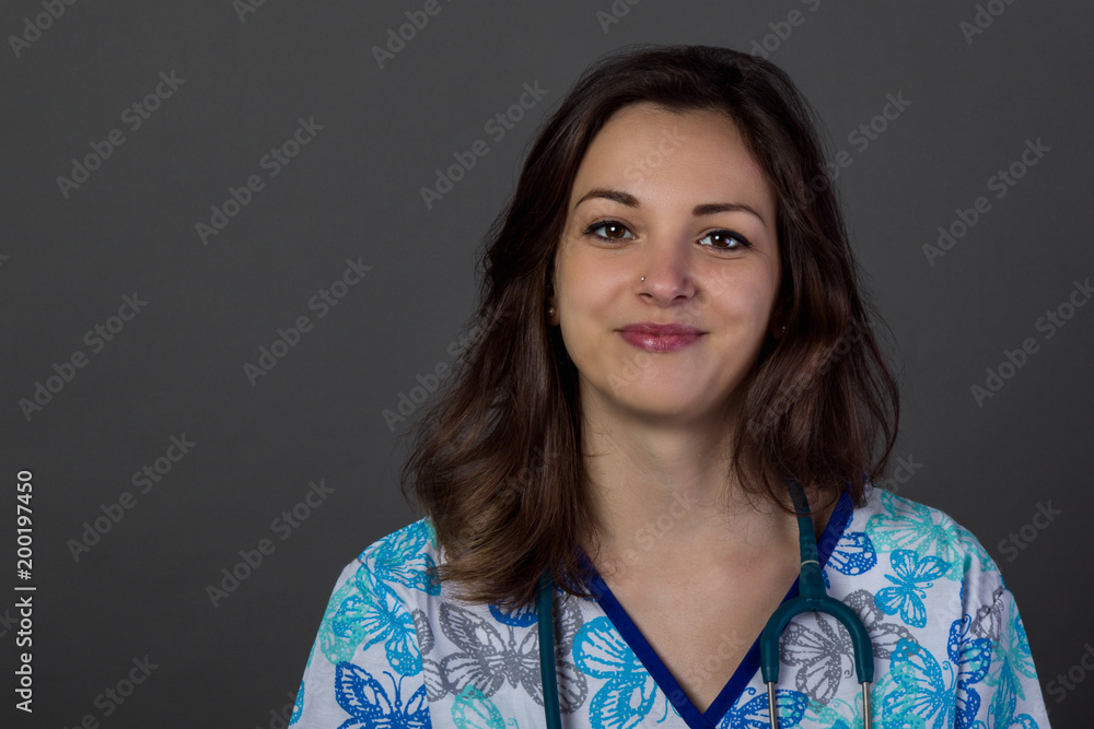 studio portrait of a young woman doctor on dark background studio portrait of a young woman doctor on dark background