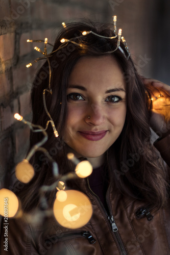 portrait of a beautiful young woman holding little lights