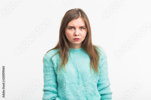 Portrait of angry woman standing on white background © satura_