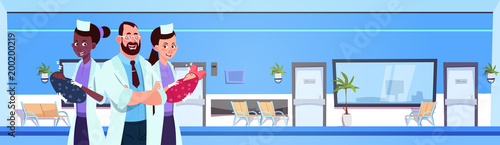 Doctor With Nurses Holding Newborn Babies Over Hospital Hall Background Flat Vector Illustration