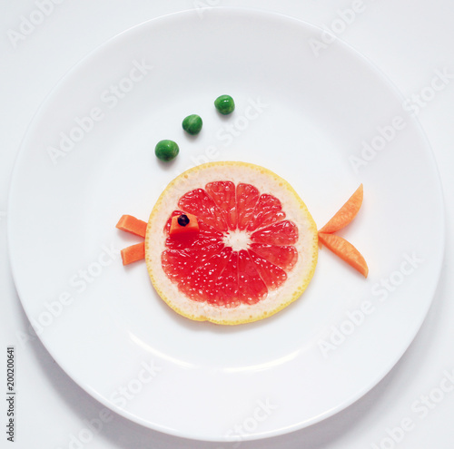stock-photo-red-fish-from-fruit- fun-food-for-kids-on-white-plate-top-view