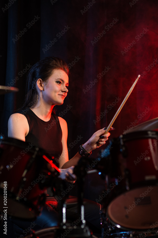 Fototapeta premium Female drummer at rock concert