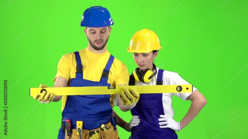 Brigadier holds a building level in his hands and measures the surface. Green screen. Slow motion Brigadier holds a building level in his hands and measures the surface. Green screen. Slow motion
