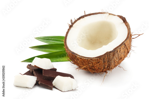 Coconut with chocolate and green leaves isolated on white background