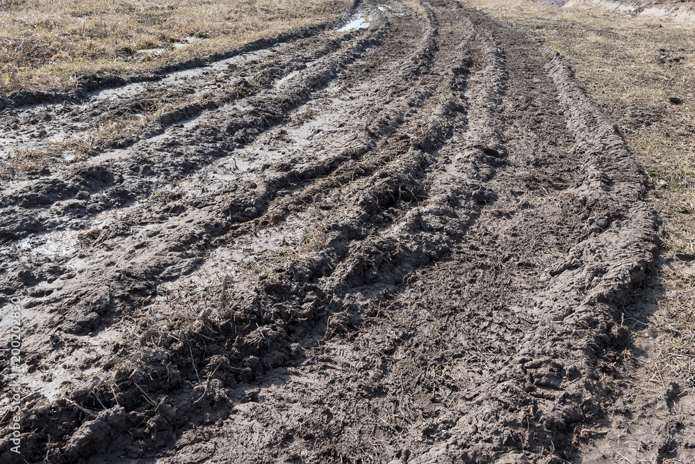 Tractor tracks in mud on a clay field in the spring. Tractor tracks in mud on a clay field in the spring.
