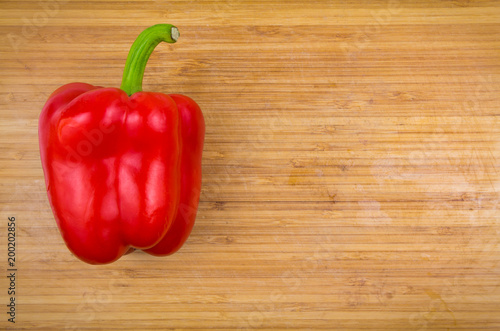Red bell pepper on bamboo cutting board