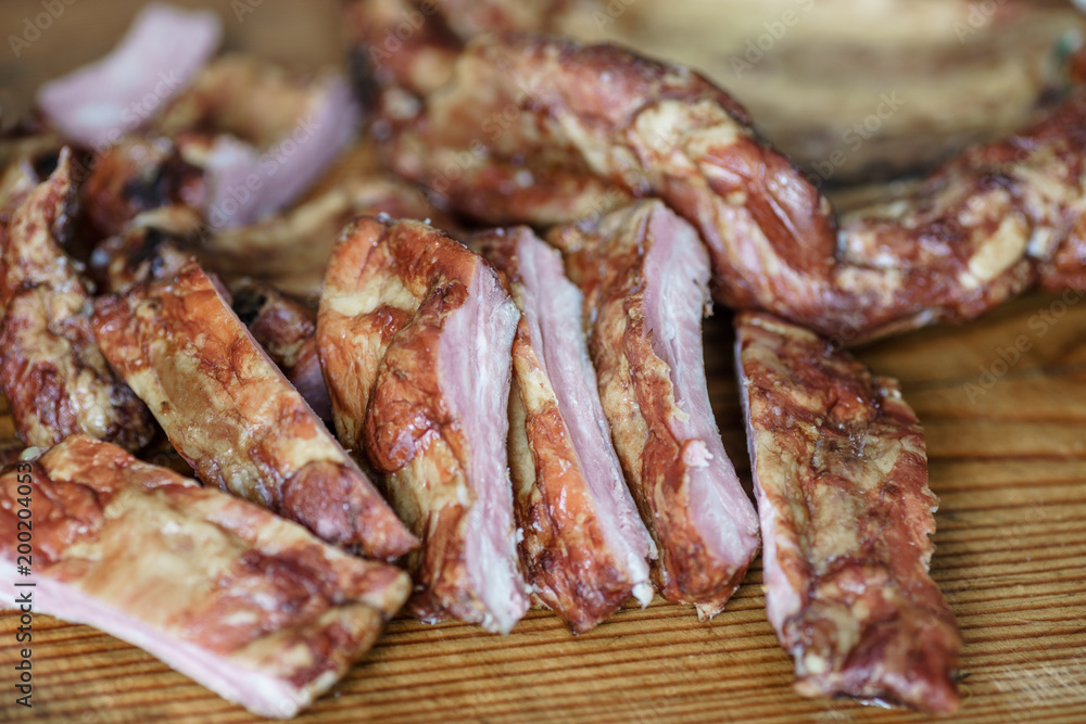 Raw pork ribs , on a wooden dinette Raw pork ribs , on a wooden dinette