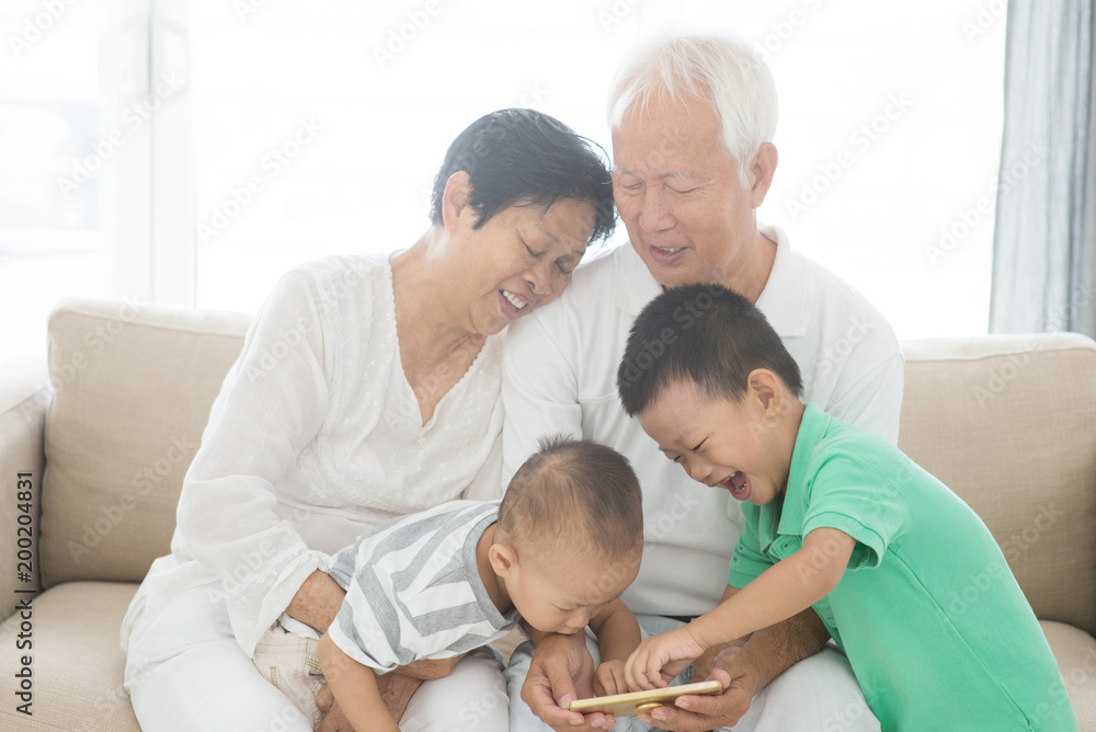 Grandparents and grandchildren using smart phones Grandparents and grandchildren using smart phones