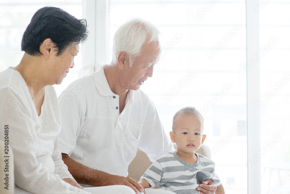 Fototapeta premium Grandparents and grandson at home