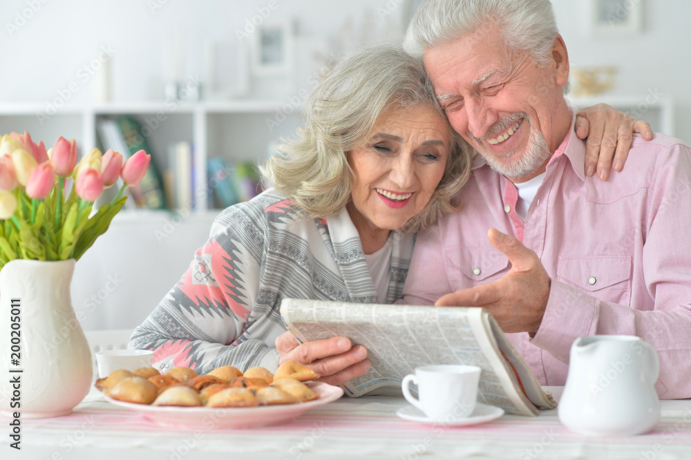 Senior couple with newspaper at home Senior couple with newspaper at home