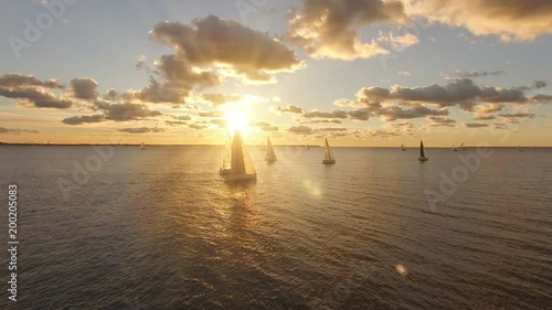 Aerial view of yachts with sails in the sea with a beautiful scenic sunset views. Yachts in the open sea photo