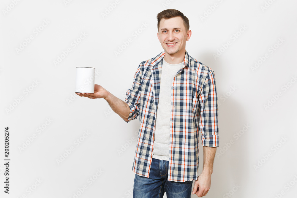 Young smiling handsome man in casual clothes holding empty paint tin can with copy space isolated on white background. Instruments, accessories for renovation apartment room. Repair home concept. Young smiling handsome man in casual clothes holding empty paint tin can with copy space isolated on white background. Instruments, accessories for renovation apartment room. Repair home concept.