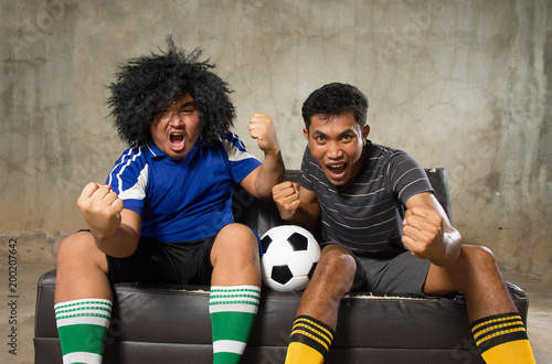 Asian man couple fan soccer football watching in TV.