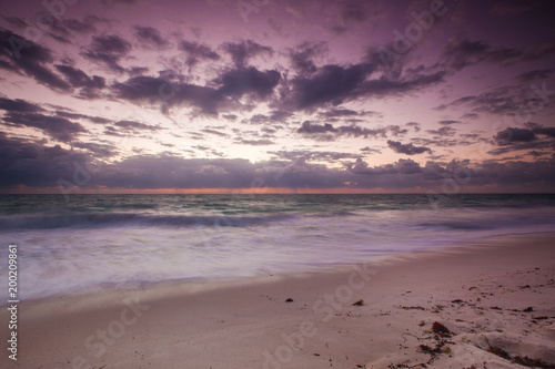 Sunrise in Cancun Mexico with sun rays coming through the clouds