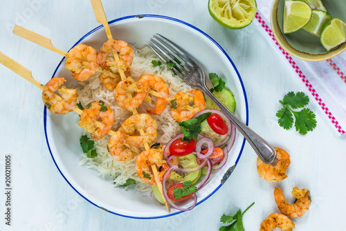 Tandoori prawn skewers with rice and chopped salad - top view