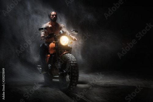 Stylish motorcycle chopper with exclusive man rider at night on the road