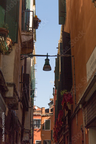 Exterior of old Italian apartment buildings with balconies and street lamp