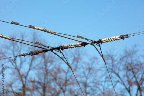 Trolleybus wires against the blue sky