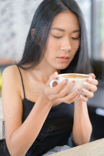 Asian woman drinking coffee for relax