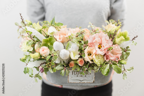 flower arrangement. beautiful luxury bouquet of mixed flowers in woman hand. the work of the florist at a flower shop. Horizontal photo