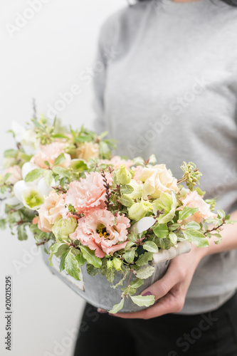 flower arrangement. beautiful luxury bouquet of mixed flowers in woman hand. the work of the florist at a flower shop. Vertical photo