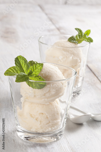Vanilla ice cream cups with mint leafs.