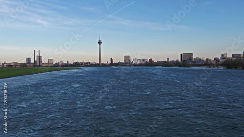 Aerial view of the Skyline of Duesseldorf while flying deep and fast over the river Rhine - Germany - Europe photo