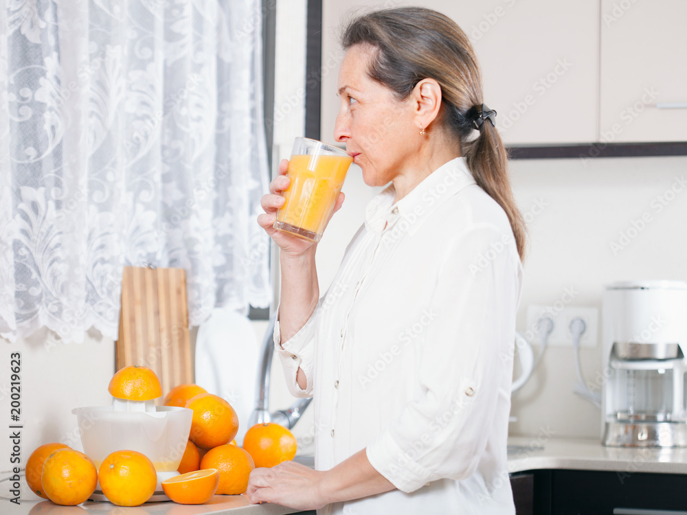woman drinking orange juice woman drinking orange juice