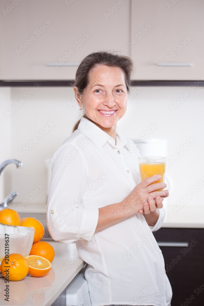 woman drinking orange juice woman drinking orange juice