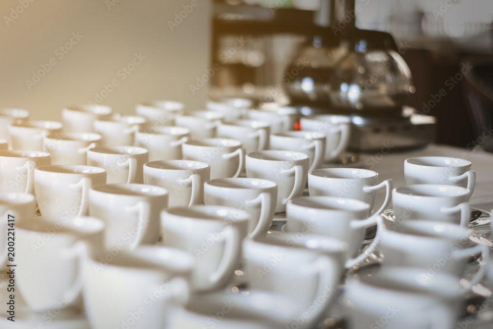 Many rows of white ceramic coffee or tea cups, in hotle Many rows of white ceramic coffee or tea cups, in hotle