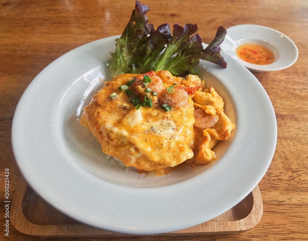 Simple Thai dish, rice with shrimp omelet on top, served at local Thai bistro cafe in Bangkok