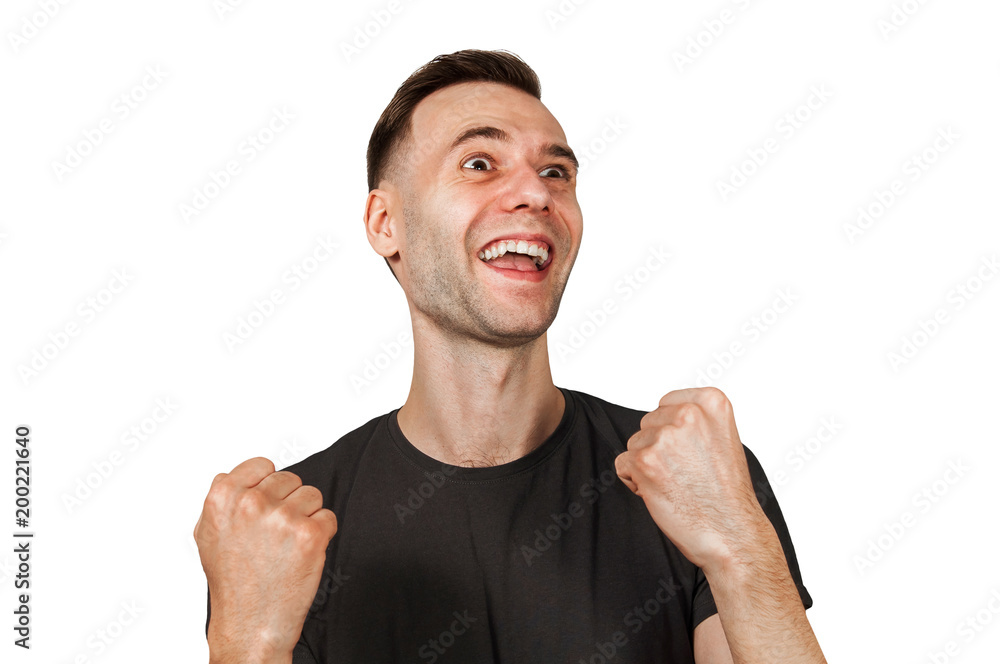 Young happy smiling man with clenched fists, looking up, isolated on white. Young happy smiling man with clenched fists, looking up, isolated on white.