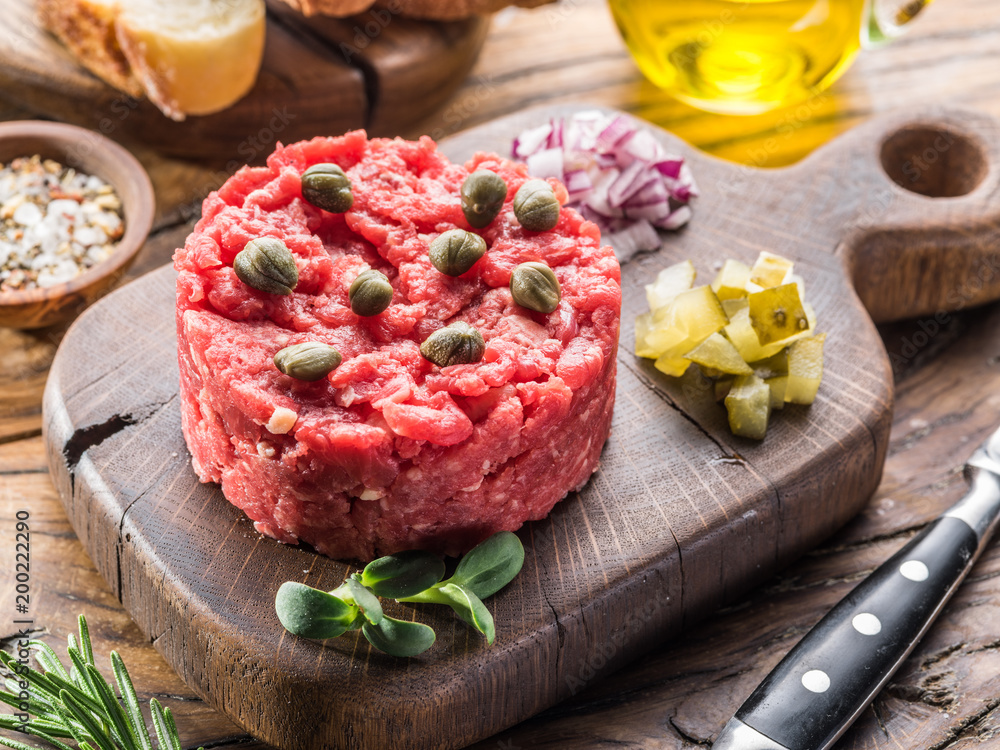 Steak tartare served with capers, pickled cucumbers and chopped onion. Steak tartare served with capers, pickled cucumbers and chopped onion.