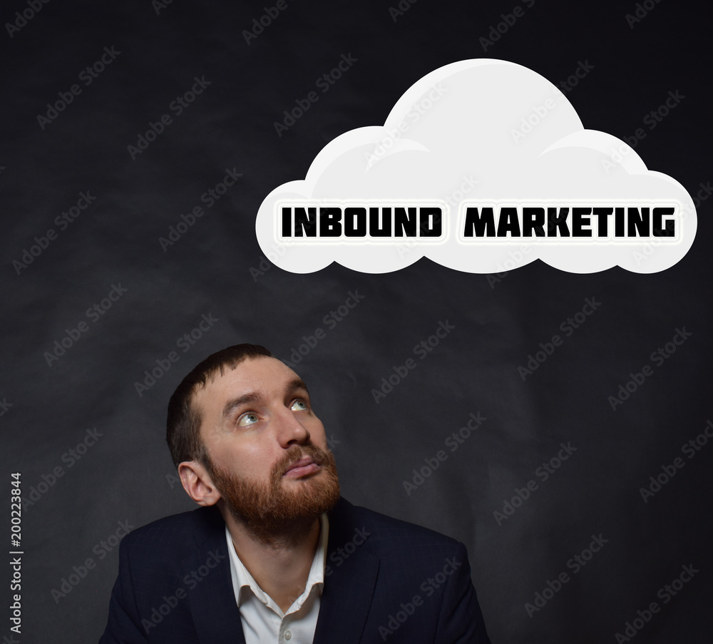 Above the businessman hangs a cloud with the inscription:INBOUND MARKETING Above the businessman hangs a cloud with the inscription:INBOUND MARKETING