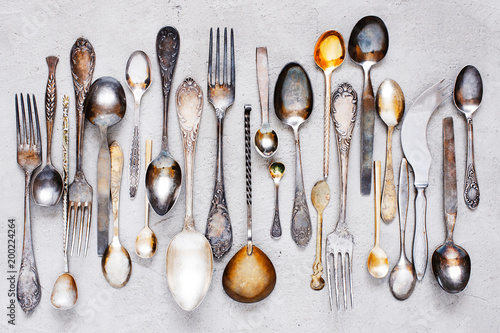 Vintage silverware lying on the grey table