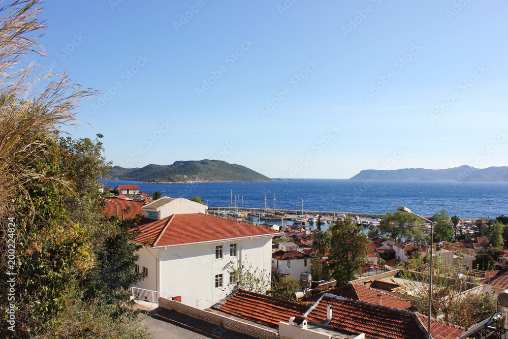Mediterranean town on the beach with red-tiled roofs. Yacht port in Kas, Turkey