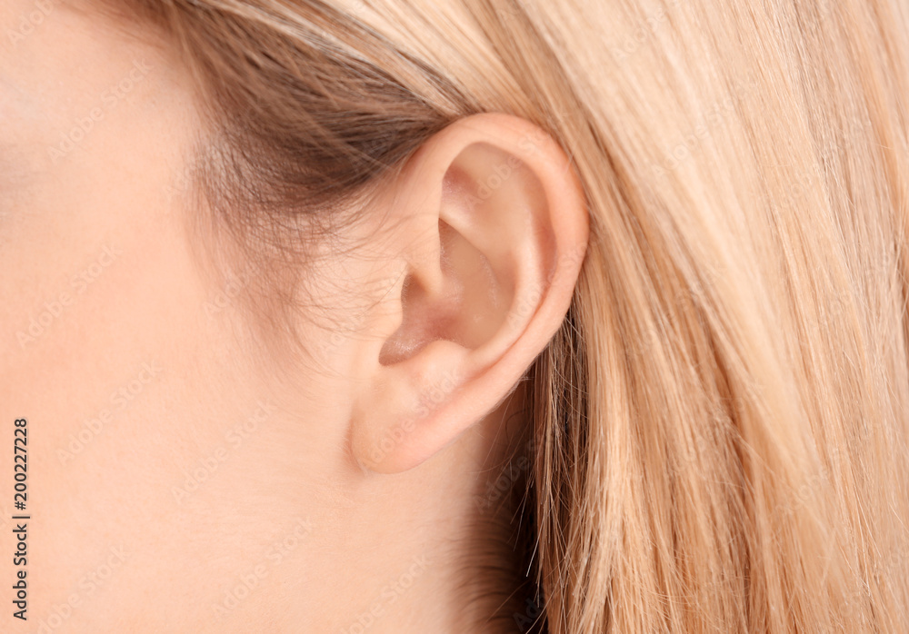Young woman, closeup. Hearing problem Young woman, closeup. Hearing problem