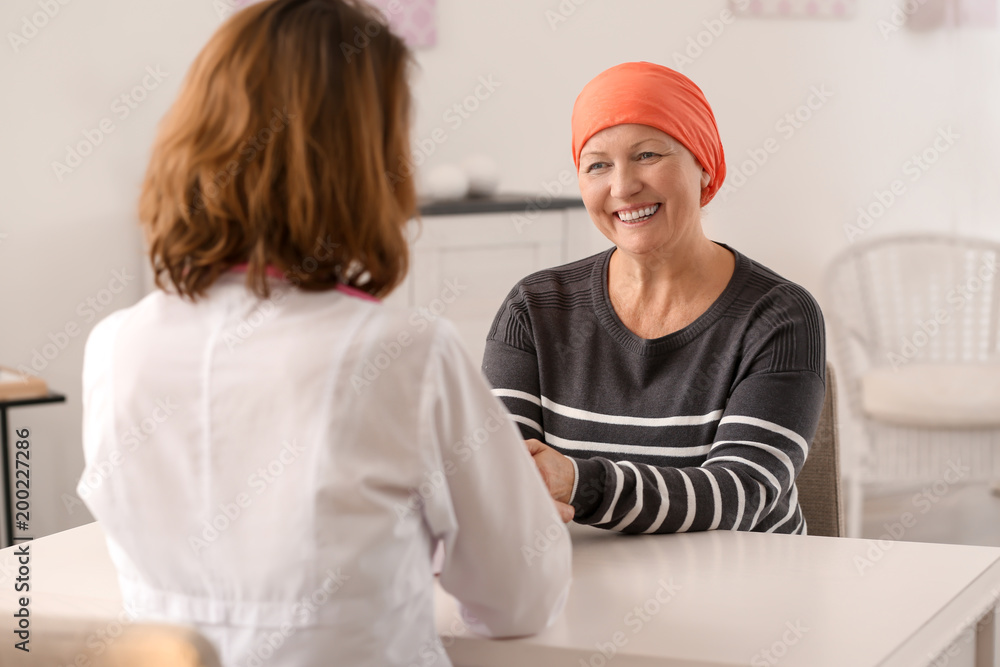 Mature woman with cancer visiting doctor in hospital Mature woman with cancer visiting doctor in hospital