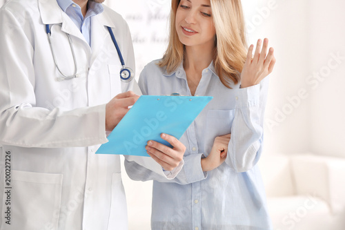 Doctor consulting female pa...