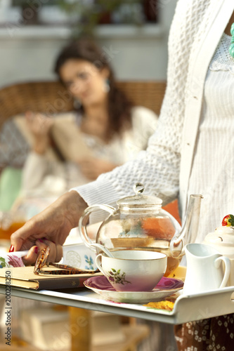 Woman serving the tea in the garden