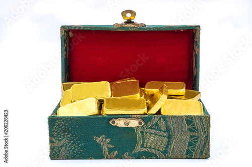 Pure gold bars in green box on white background. photo