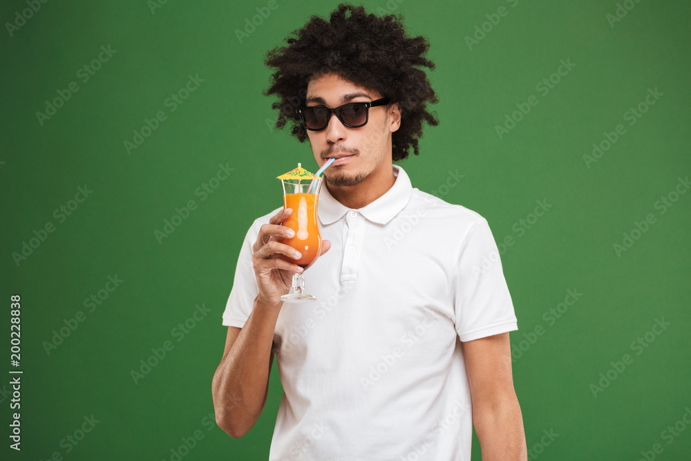 Serious young african curly man drinking cocktail. Serious young african curly man drinking cocktail.