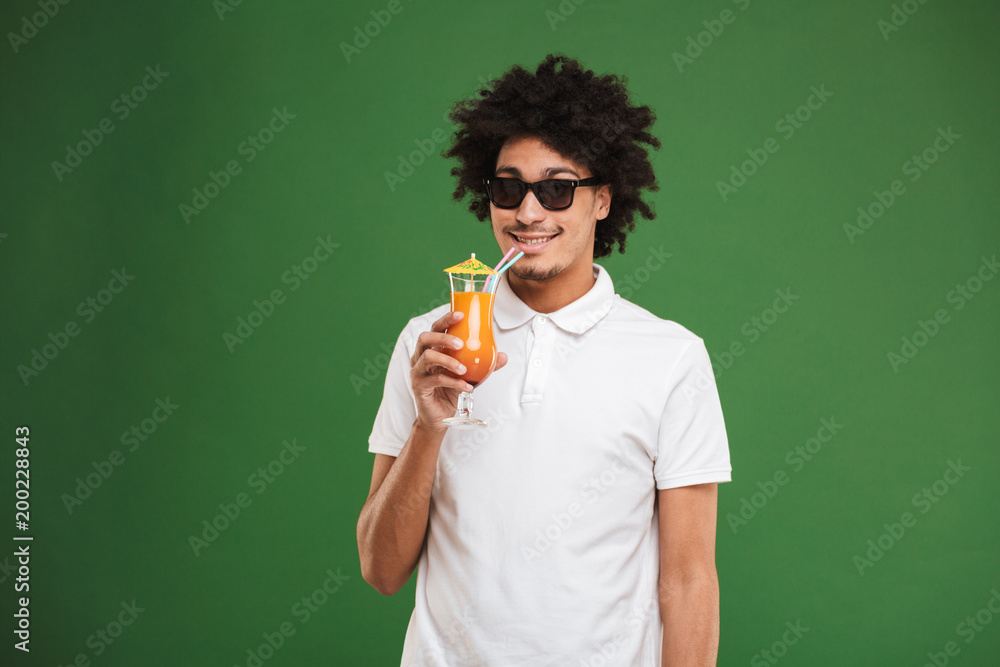 Happy young african curly man drinking cocktail. Happy young african curly man drinking cocktail.