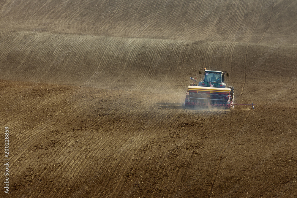 tractor with seed drill on field tractor with seed drill on field