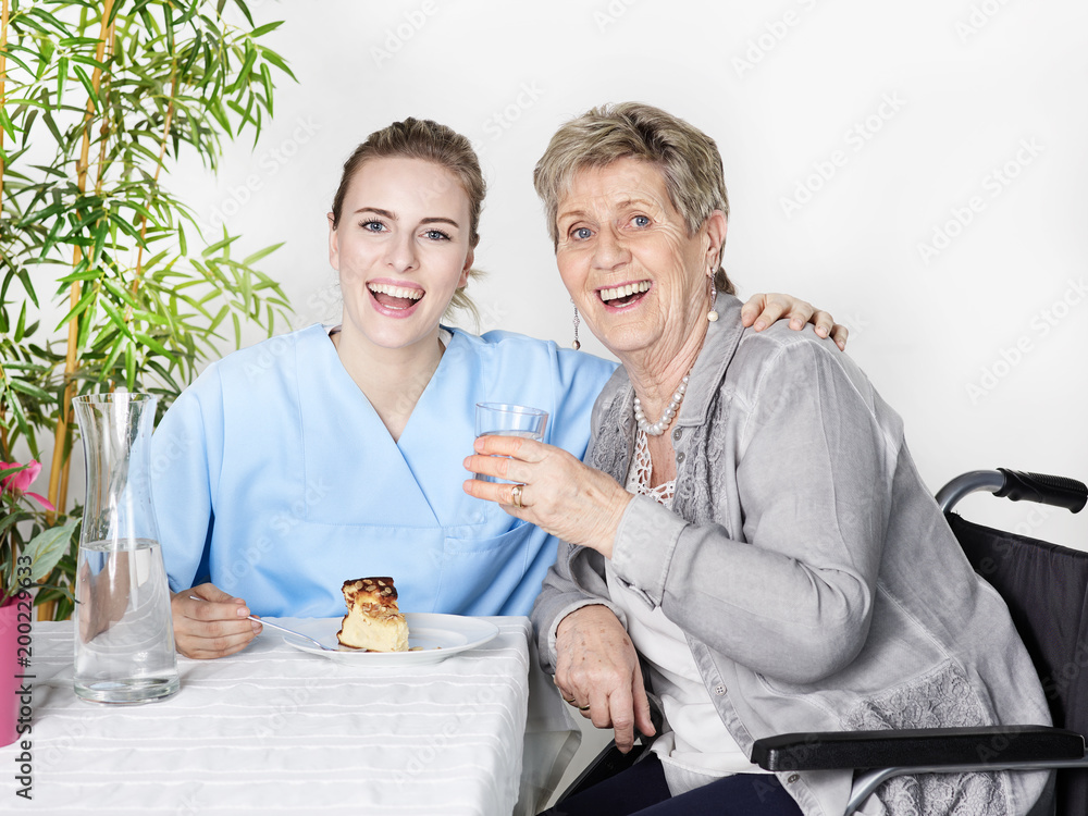 Carer spoon-feeds a elderly person Carer spoon-feeds a elderly person