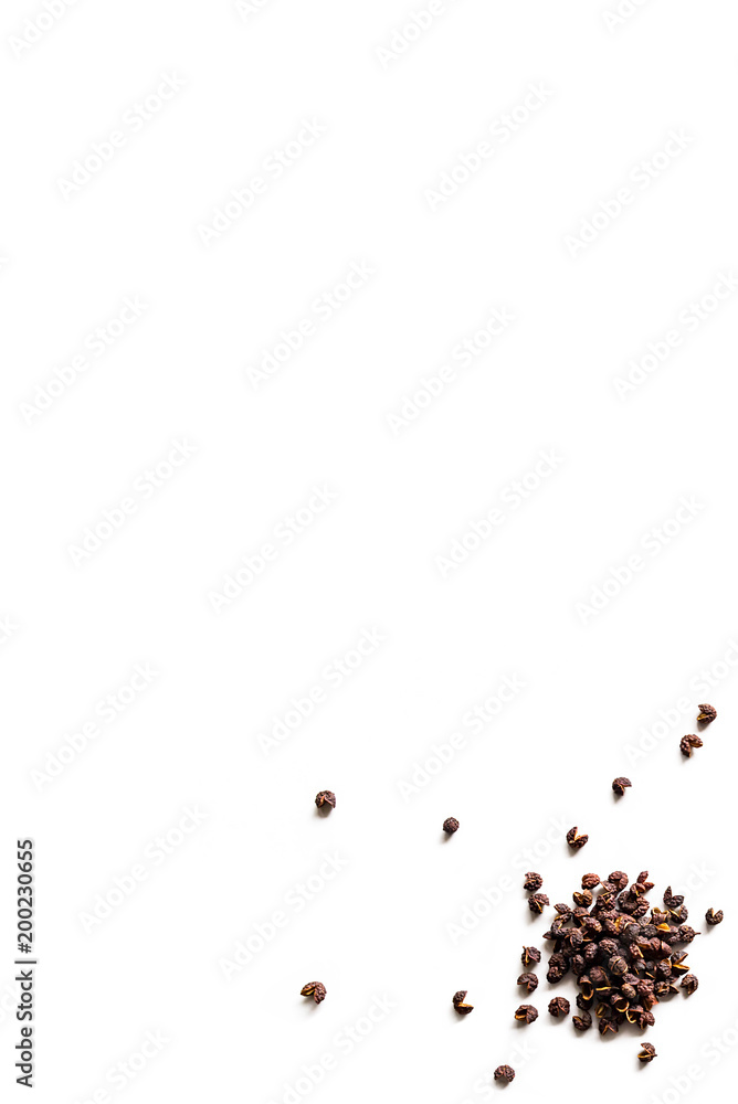 Dried whole seed of Neapli Timut pepper isolated on a white background.  Vertical composition. Top view